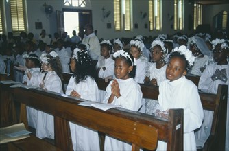 SEYCHELLES, Baie Lazare, Young girls attending first communion.