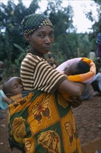 TANZANIA, West, Great Lakes Region, Mkugwa Refugee Camp.  Portrait of woman with two babies.