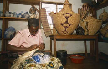 TANZANIA, West, Great Lakes Region, Refugee making traditional woven baskets.