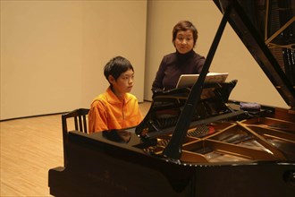 JAPAN, Chiba, Tako, 11 year old boy named Satoshi Ui plays the piano at his recital