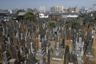 JAPAN, Honshu, Tokyo, Yanaka. View over the cemetary of Shoyomei-ji Temple closely surrounded by