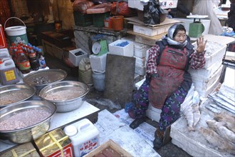 KOREA, Seoul, Namdaenum Market on a cold December day. Elderly woman negotiates price with a buyer