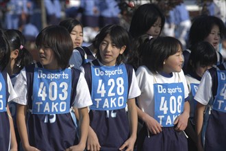 JAPAN, Chiba, Tako, 11-12 year old girls await the start of 2 kilometer race which is part of the