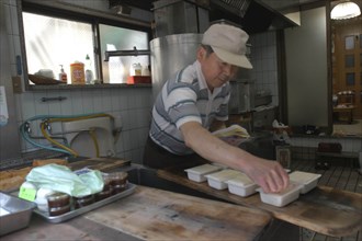 JAPAN, Honshu, Tokyo, "Yanak. Mr. Kyuhei Fukushima, 68 years old, at work in his tofu shop"