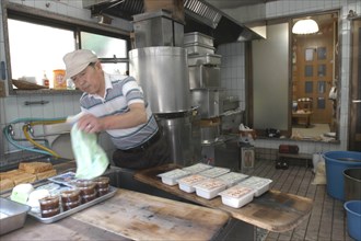 JAPAN, Honshu, Tokyo, "Yanak. Mr. Kyuhei Fukushima, 68 years old, at work in his tofu shop"