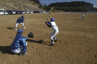 JAPAN, Chiba, Tako, "Coach Ishii checks batting form of 11 year old 5th grader, Yuki Katsumata,