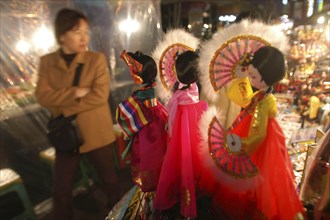 KOREA, Seoul, "Namdaemun Market on a cold December night with customer looking at sounvenir dolls