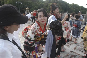JAPAN, Honshu, Tokyo, Harajuku. A member of the Kyoto Rokumeikan troupe has her hair adjusted