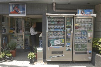 JAPAN, Honshu, Tokyo, Nezu. Cigarette shop with cigarette vending machines