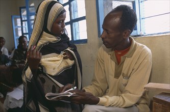SOMALILAND, Boroma, Male teacher with pupil at Fatima Bihi Primary School.