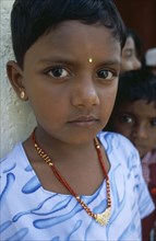 SRI LANKA, Dambetenne, Portrait of a young schoolgirl wearing gold jewellery