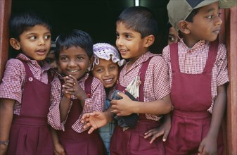 SRI LANKA, Dambetenne, Group of young school children wearing red uniform