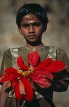 SRI LANKA, Haputale, Portrait of a girl holding a large red flower