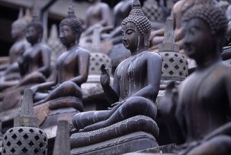 SRI LANKA, Colombo, Gangaramaya Temple. Mass of seated Buddha statues
