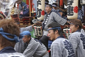 JAPAN, Chiba, Narita, Men in traditional Edo-era costumes wait to pull their neighborhood dashi or
