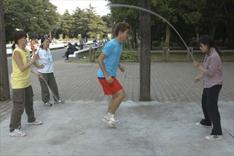 JAPAN, Honshu, Tokyo, "Harajuku. Yoyogi Park. 24 year old student Kusan Osaki, jumps rope with