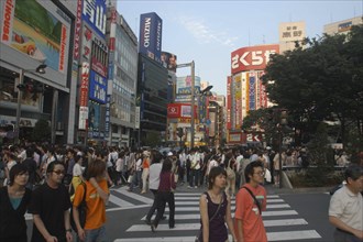JAPAN, Honshu, Tokyo, Crowds on pedestrian crossing on Shinjuku-dori avenue on Saturday evening