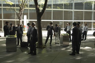 JAPAN, Honshu, Tokyo, "Yurakucho. A group of male salaried workers called salariman, smoking at a