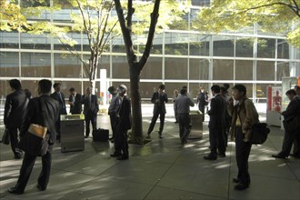 JAPAN, Honshu, Tokyo, "Yurakucho. A group of male salaried workers called salariman, smoking at a