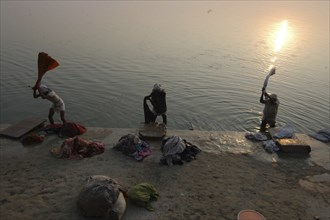 INDIA, Uttar Pradesh, Varanasi , Near Shivala Ghat. Dhobi clothes washers working on the banks of