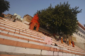 INDIA, Uttar Pradesh, Varanasi, Chauki Ghat steps leading up to a Shiva shrine with worshippers