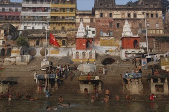 INDIA, Uttar Pradesh, Varanasi , Dashaswamedh Ghat with early morning bathers in the Ganges River