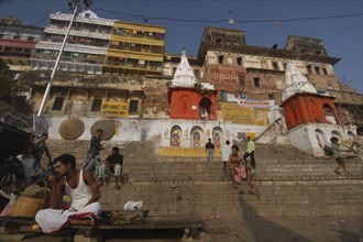 INDIA, Uttar Pradesh, Varanasi, Dasashwamedh Ghat. View looking up at a temple and the houses