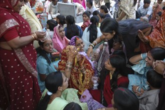 INDIA, Uttar Pradesh, Varanasi, Sankat Mochan Mandir temple. Women friends and relatives cheer a