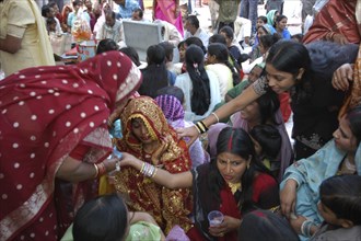 INDIA, Uttar Pradesh, Varanasi, Sankat Mochan Mandir temple. Women friends and relatives comfort