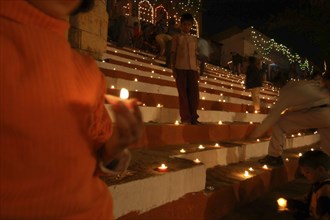 INDIA, Uttar Pradesh, Varanasi, Deep Diwali festival with oil lamps on the steps leading down to