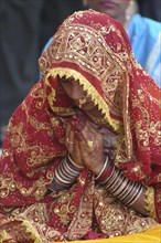 INDIA, Uttar Pradesh, Varanasi, Sankat Mochan Mandir temple. Hindu bride dressed in red and gold