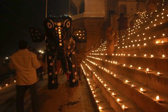 INDIA, Uttar Pradesh, Varanasi, Deep Diwali Festival with paper statue of Hindu God Ganesh on steps