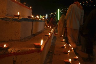 INDIA, Uttar Pradesh, Varanasi, Deep Diwali Festival. Oil lamps and crowds line the steps of the