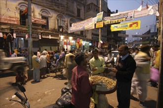 INDIA, Uttar Pradesh, Varanasi, Dasashwamedh Ghat. Market scene at dusk