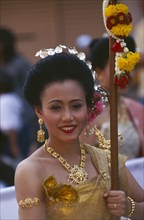 THAILAND, Chiang Mai, Portrait of young woman marching in the Flower Festival parade