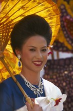 THAILAND, Chiang Mai, Portrait of young woman riding the beauty contest float in the Flower