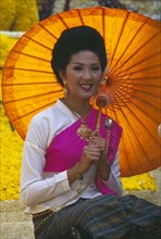 THAILAND, Chiang Mai, Portrait of young woman riding the beauty contest float in the Flower