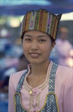 THAILAND, Chiang Mai, Wat Pa Pao. Portrait of a young Shan woman in traditional Shan attire at a