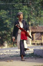 MYANMAR, Kachin State, Myitkyina, Manou grounds. Old Jinghpaw man in traditional attire with sword