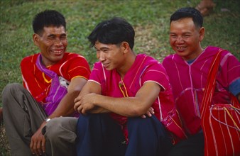 THAILAND, Chinag Mai, Wat Sri Soda, Three Karen men in red tunics and shoulder bags