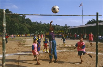 THAILAND, Chiang Rai Province, Doi Lan, Lisu boys playing soccer in a village school yard