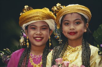 THAILAND, Chiang Mai, Two young Thai girls in traditional northern Thai attire for the Flower