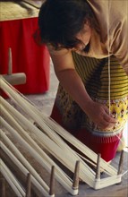 THAILAND, Chiang Mai, Mae Jaem, Thai woman winding thread in to a skein