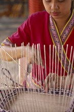 THAILAND, Chiang Mai, Thai woman making a basket