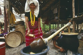 THAILAND, Chiang Mai Province, Sgaw Karen woman brewing rice liquor