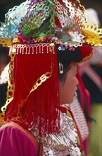 THAILAND, Chiang Rai Province, Huai Khrai, Portrait of a young Lisu woman in her New Year finery