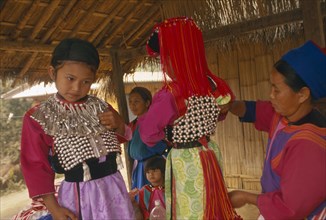 THAILAND, Chiang Rai Province, Huai Khrai, Young Lisu girls dressed in their New Year finery while