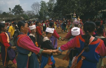 THAILAND, Chiang Rai Province, Huai Khrai, Lisu people dancing around a New Year tree to a banjo