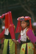 THAILAND, Chiang Rai Province, Huai Khrai, Lisu girls dancing wearing their New Year finery