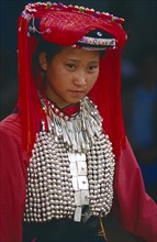 THAILAND, Chiang Rai Province, Huai Khrai, Portrait of a young Lisu woman wearing her New Year